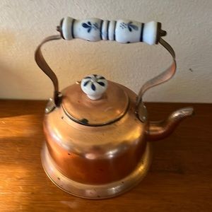 Vintage copper kettle with blue handles